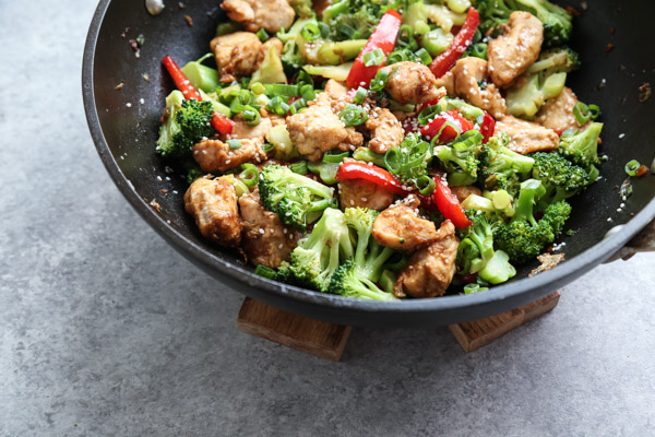 Sesame Chicken with Broccoli and Red Peppers in a Wok