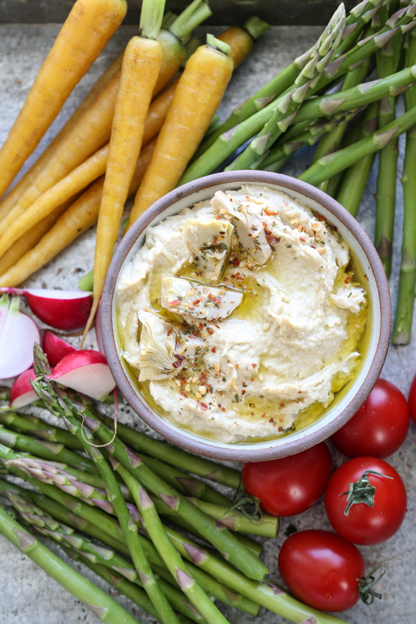 bowl of hummus with crudites on a tray