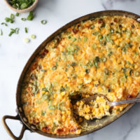 corn pudding with scallions in a casserole pan