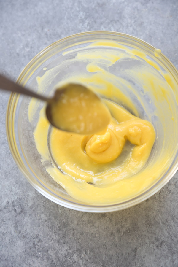 healthy dairy-free lemon curd in a bowl with a spoon