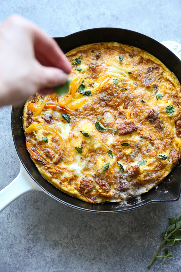 herbs on a italian sausage frittata recipe in a skillet