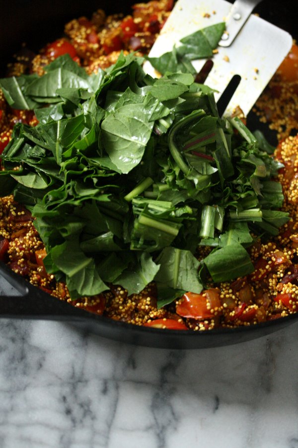 Dandelion greens are a great addition to this healthy paella recipe with clams and Spanish chorizo. 