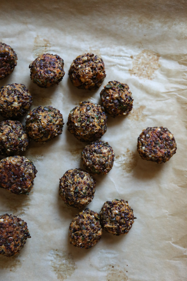 crispy gluten-free Quinoa Lentil Meatballs on a sheet pan after being baked
