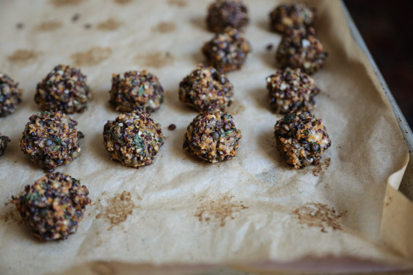 crispy gluten-free Quinoa Lentil Meatballs on a sheet pan after being baked
