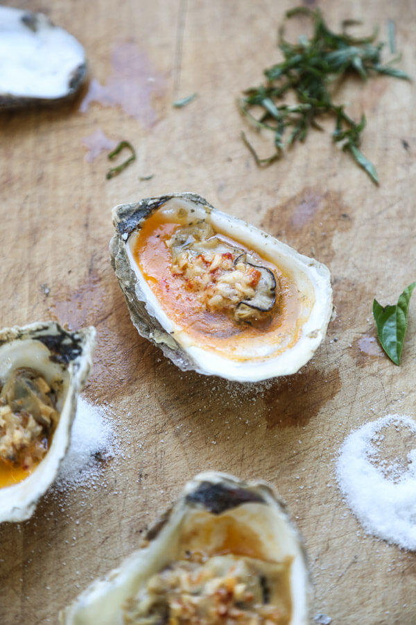 These grilled oysters are topped with an addictive chipotle bourbon butter, inspired by the BBQ oysters at Hog Island Oyster. They're also great broiled! | Recipe on Feed Me Phoebe