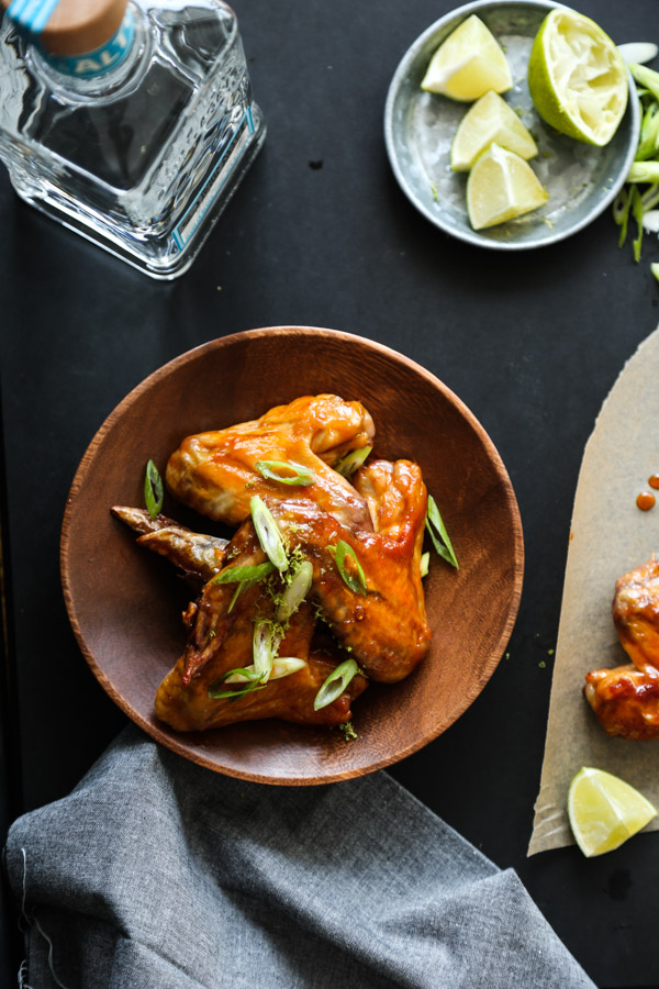 CHIPOTLE HONEY LIME CHICKEN WINGS // this easy baked chicken wings recipe uses the oven to render the skin and make it crispy and healthy(ish). Plus, the honey-lime chipotle sauce has tequila in it! // FEED ME PHOEBE
