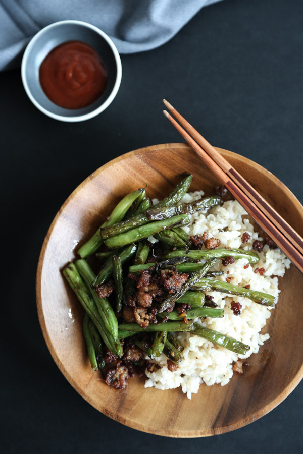 These Chinese stir fry green beans are loaded with spicy chiles, crispy pork, and zesty ginger. The recipe is a great takeout fakeout and just as quick! | FEED ME PHOEBE