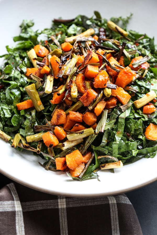 This massaged kale salad recipe is tossed with roasted butternut squash, crispy scallions and a sweet chili dressing. The perfect fall side dish! 