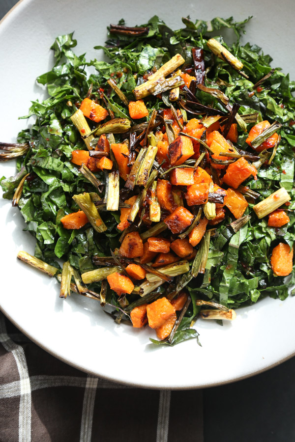 This massaged kale salad recipe is tossed with roasted butternut squash, crispy scallions and a sweet chili dressing. The perfect fall side dish!