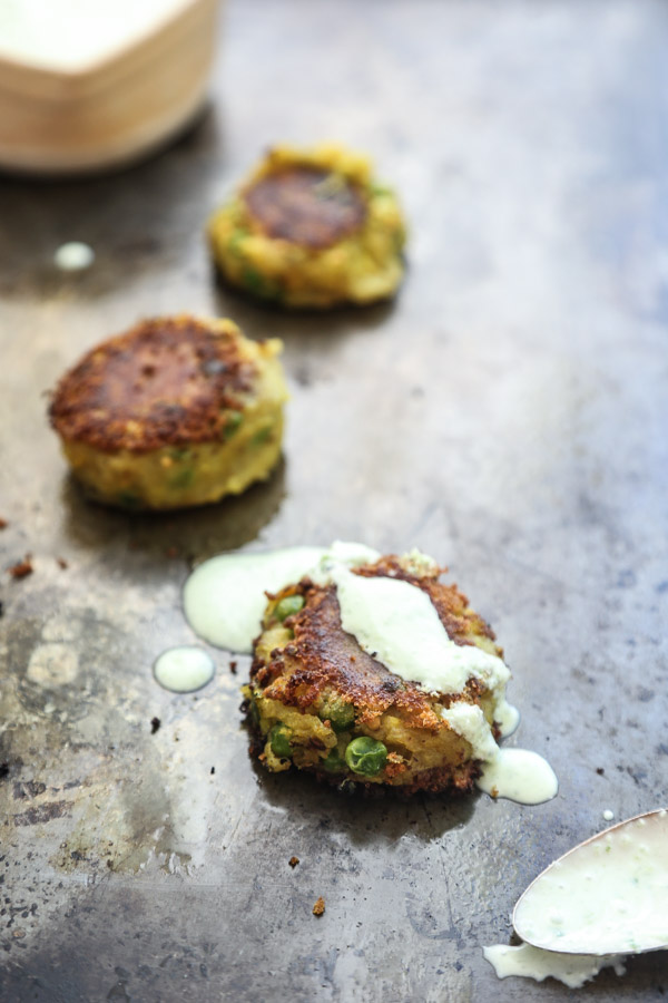 Samosa-Style Mashed Potato Cakes with Ginger Scallion Yogurt Sauce // If you're looking for leftover mashed potato recipes, this version with Indian spices is a great makeover that tastes like a crustless samosa! 