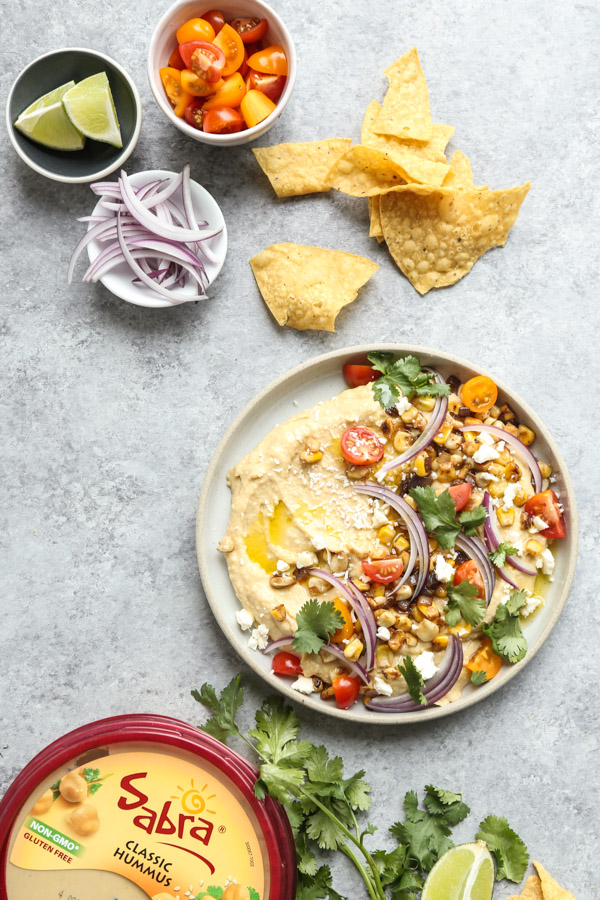 Loaded Southwestern-Style Spicy Hummus with Corn, Cherry Tomatoes, Cilantro and Red Onions | Using @sabra as the base! 