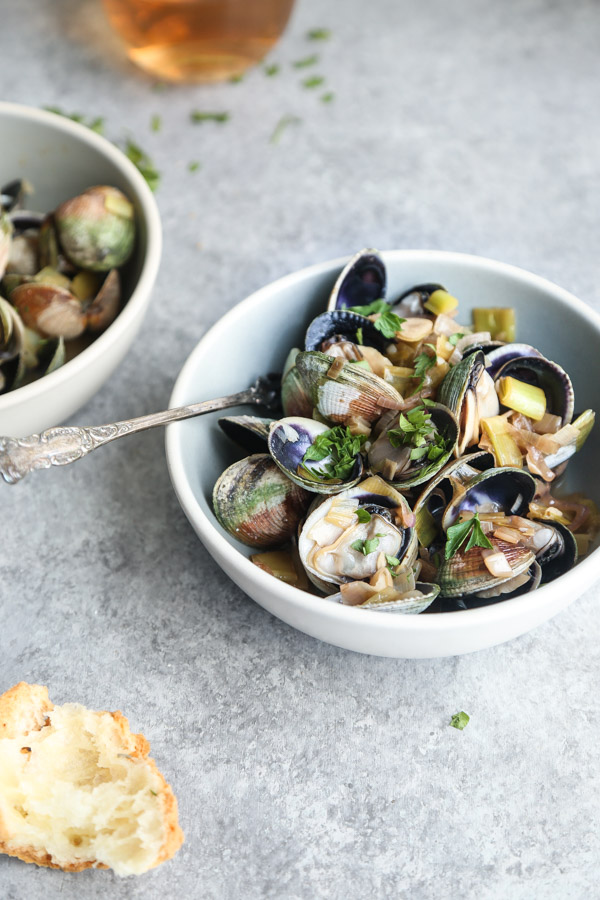 Rosé Wine Steamed Clams Recipe with Leeks and Oregano. The perfect way to use up all that summer seafood and rosé!