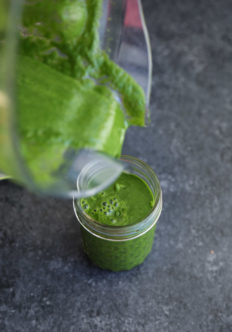 pouring green smoothie from blender