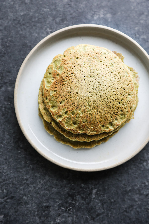 stack of green pancakes on a plate