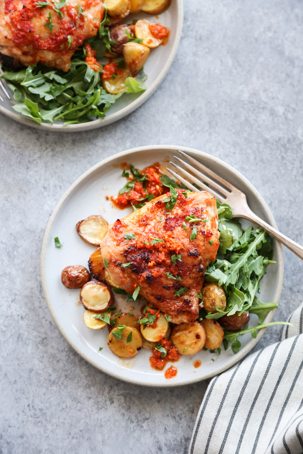 peri peri chicken plated with salad and potatoes