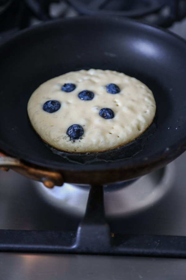blueberry pancake in a skillet on the stove