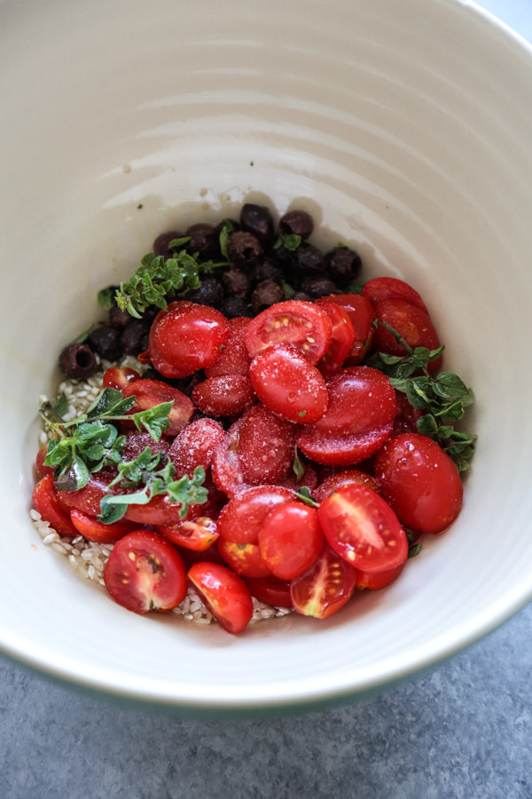 cherry tomatoes and herbs in a bowl