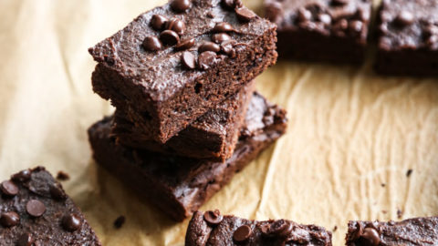 stack of brownies on parchment paper board