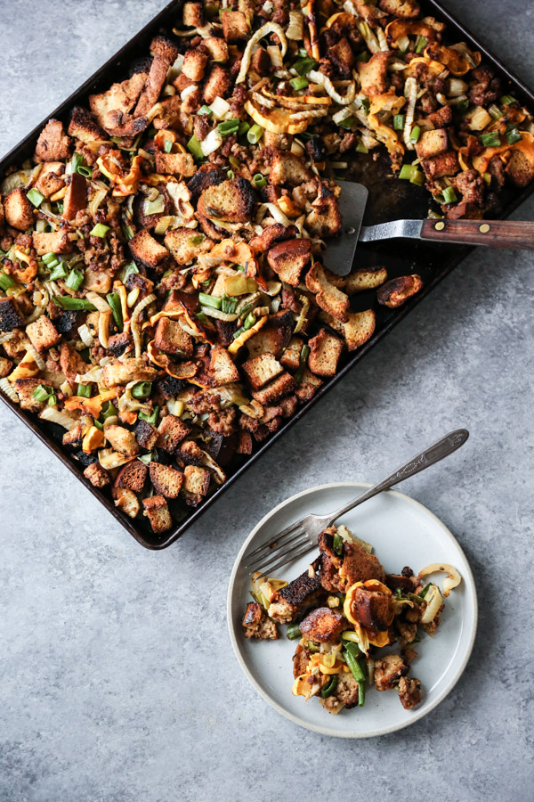 sheet pan thanksgiving stuffing with spatula and stuffing on a plate