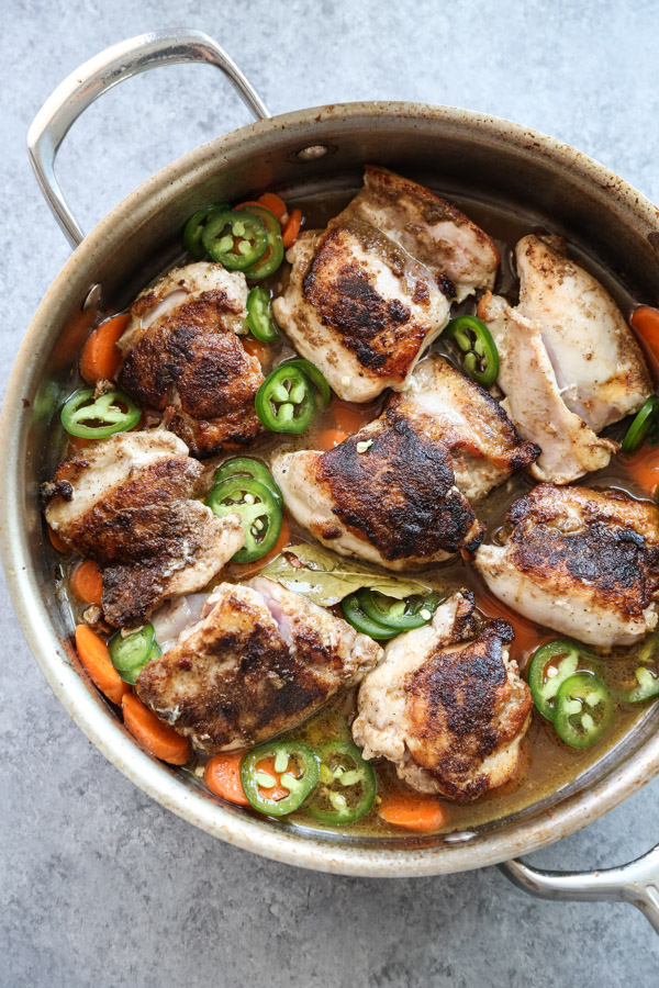 low fodmap chicken thighs in a pan with jalapenos and carrots