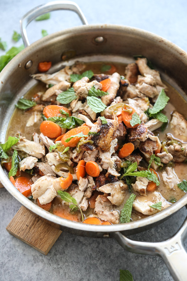 low fodmap chicken thighs shredded in a pan with jalapenos and carrots - ready to be taco filling