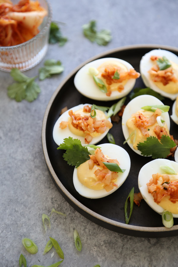 deviled eggs on a plate with herbs