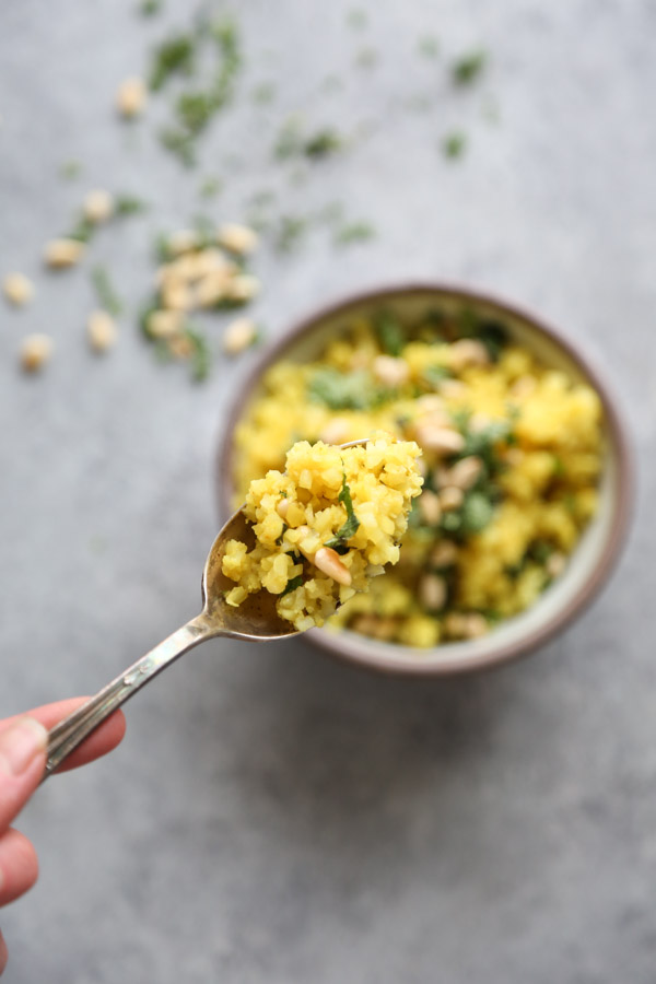 cauliflower couscous with a spoon in a bowl