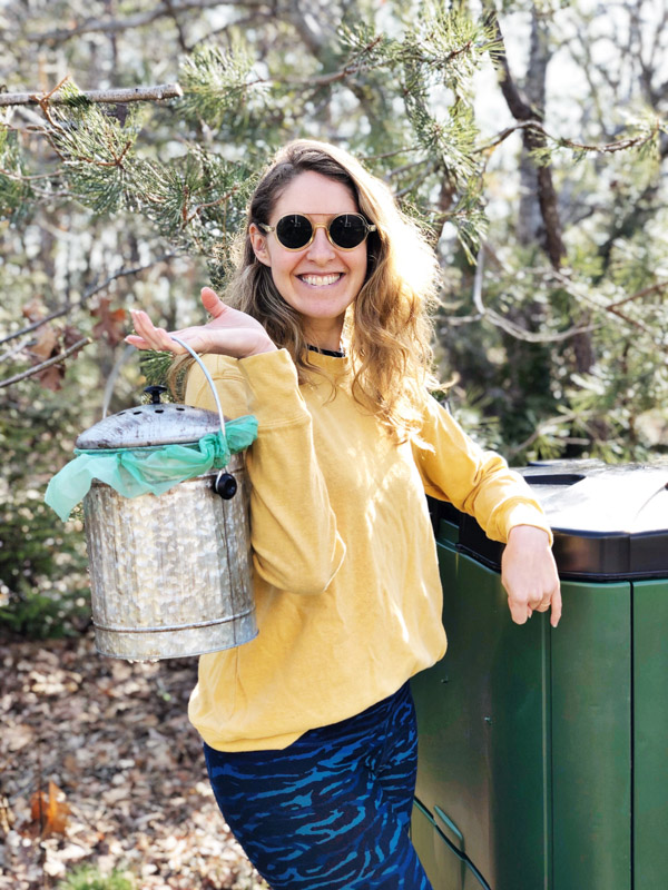 woman holding countertop compost bin