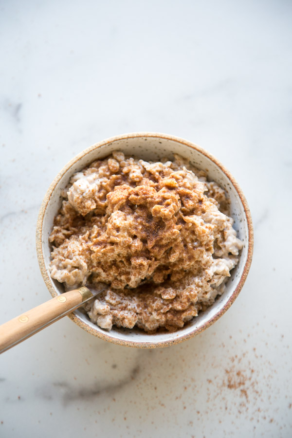 The Best 15-Minute Low FODMAP Oatmeal Recipe - creamy oatmeal in a bowl with cinnamon and coconut sugar on top | Feed Me Phoebe