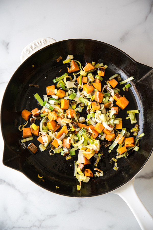 carrots and leeks sauteed in a skillet