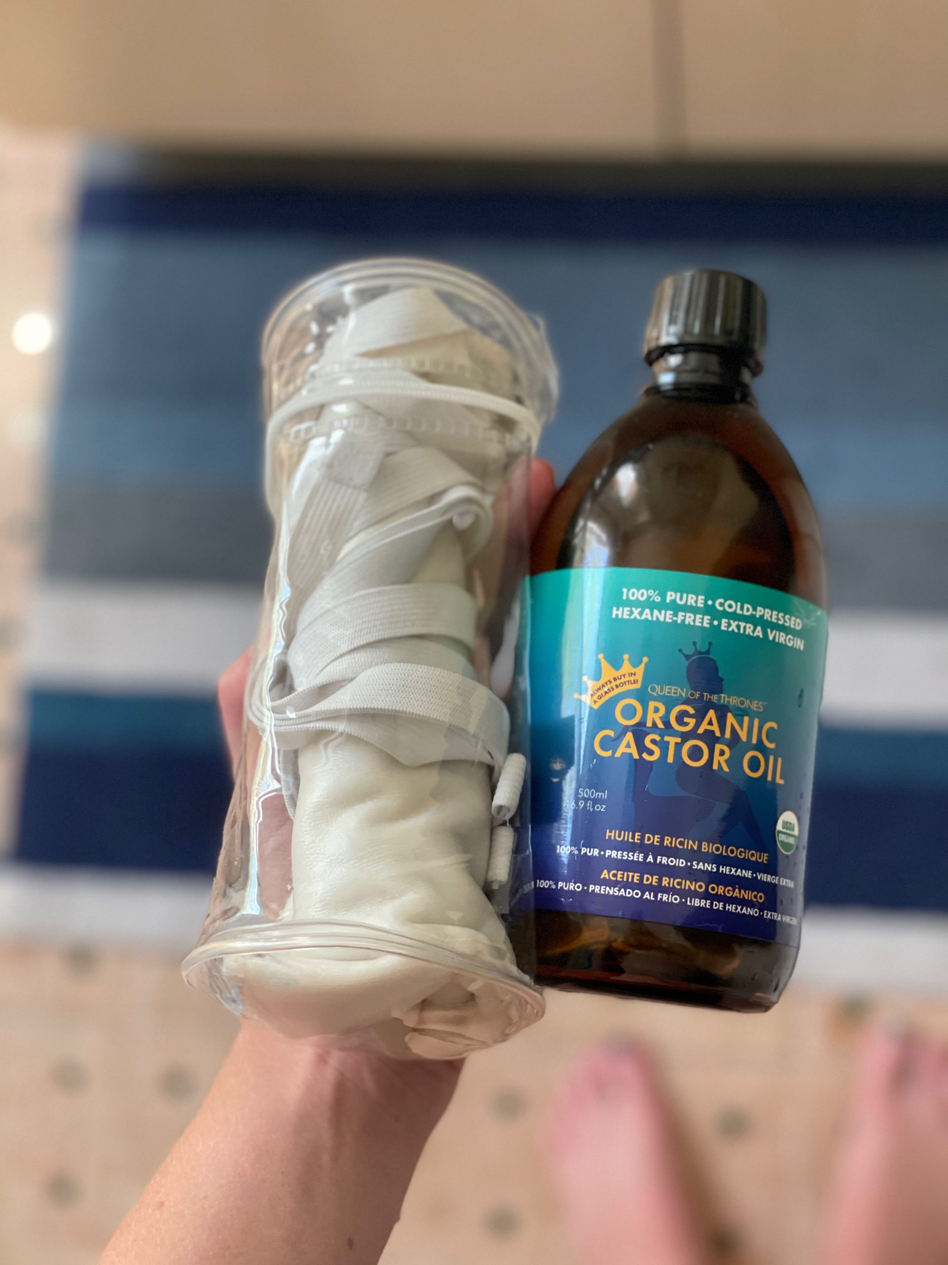 hand holding the best castor oil for liver detox and castor oil pack in case