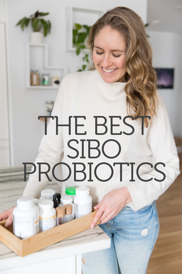 author holding a tray of SIBO probiotics in the kitchen