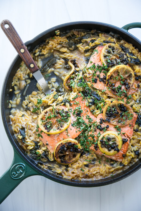 low fodmap salmon and orzo dinner in a skillet with a spatula