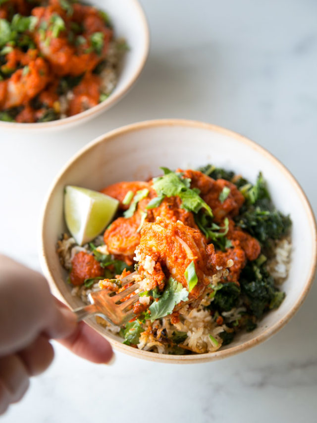Low fodmap shrimp diablo in a bowl with a hand holding a fork