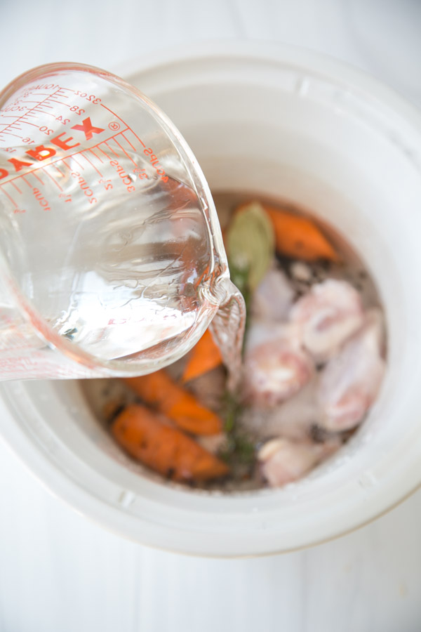 water for gluten-free chicken stock pouring into slow cooker