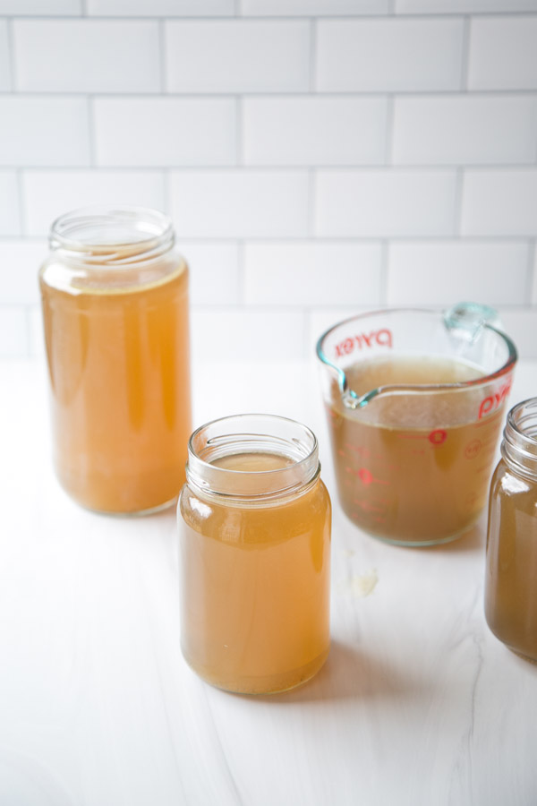 Gut-Healing Low FODMAP Chicken Stock Recipe for Soup in jars and cup measures