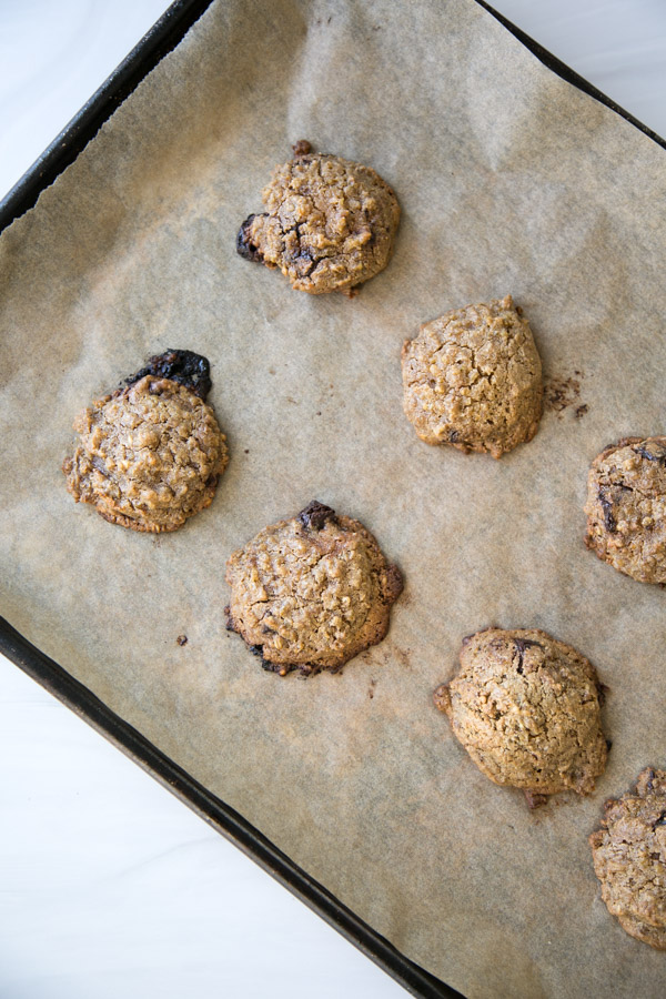 baked steel cut oat cookies with chocolate chunks on a sheet pan