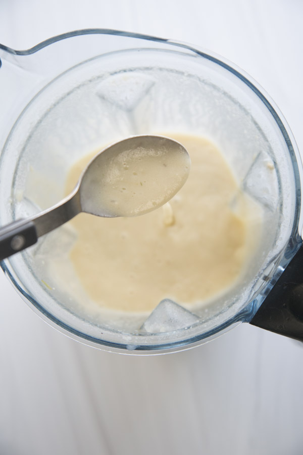 blender full of dairy-free cream of chicken soup with spoon