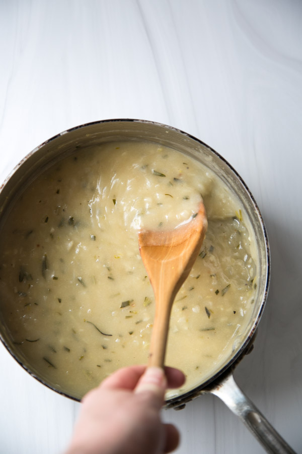 spoon stirring gluten-free gravy without cornstarch in a pan