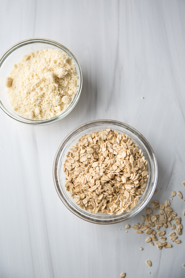 bowl of almond flour next to bowl of whole rolled oats