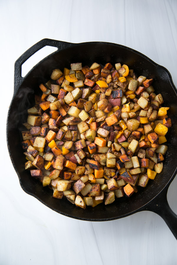 skillet with low fodmap vegan breakfast hash potatoes - regular and sweet potato cooked stovetop