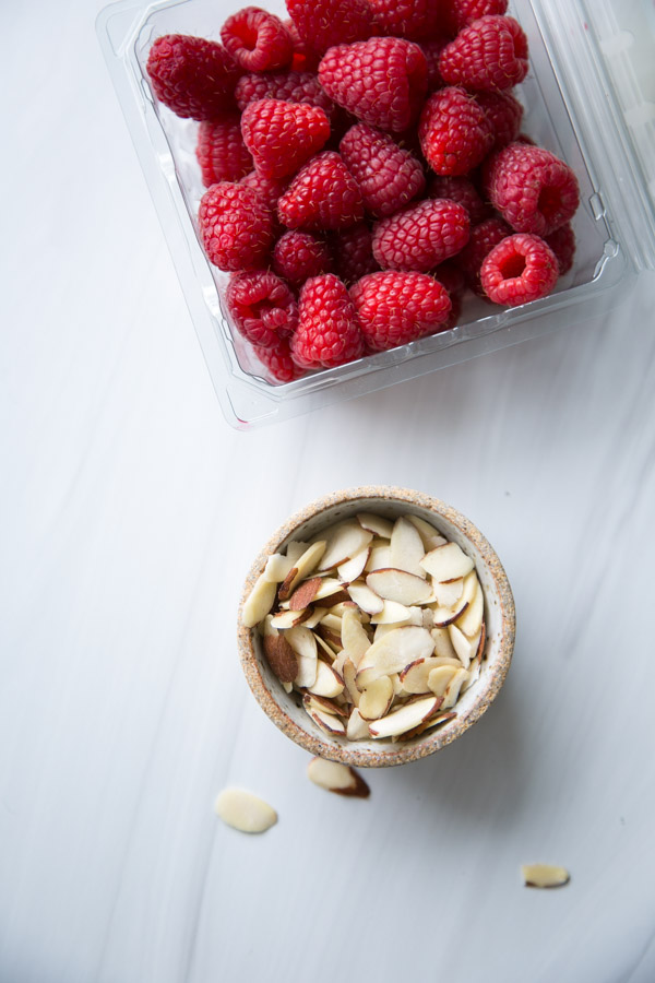 Raspberries and almonds in bowl