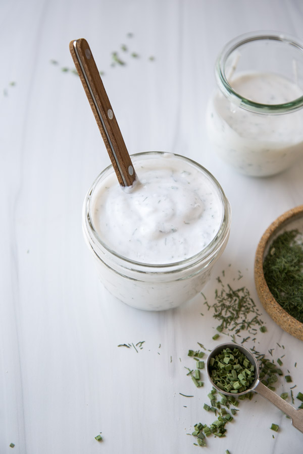 jar full of Dairy-Free Ranch Dressing next to dried gluten-free herb mix