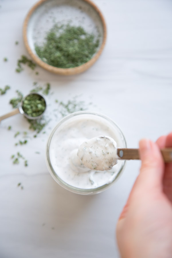 hand holding spoon of Dairy-Free Ranch Dressing