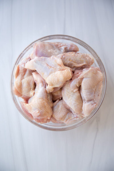 Raw chicken wings in bowl