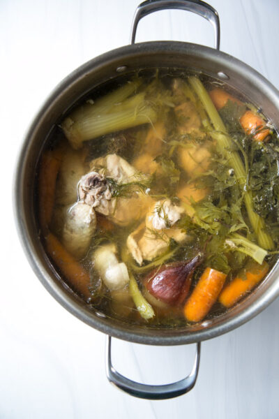 Jewish chicken soup in a pot with vegetables