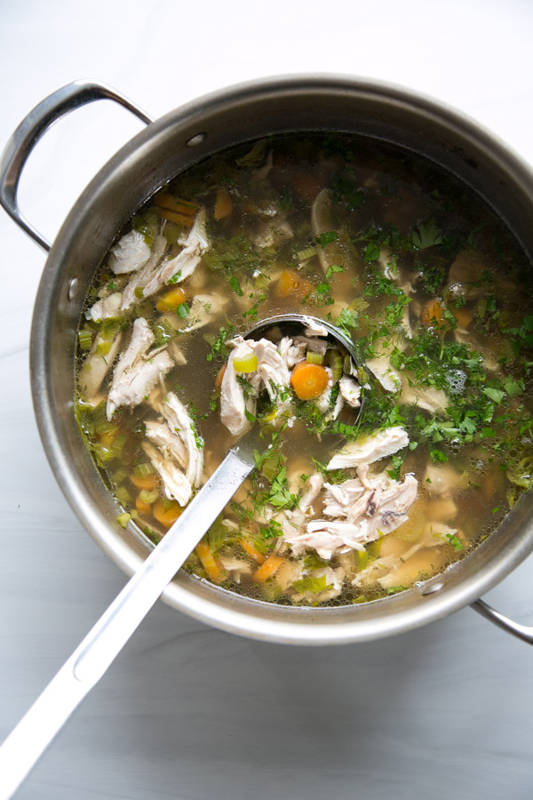 Jewish chicken soup for passover seder in a pot with ladle