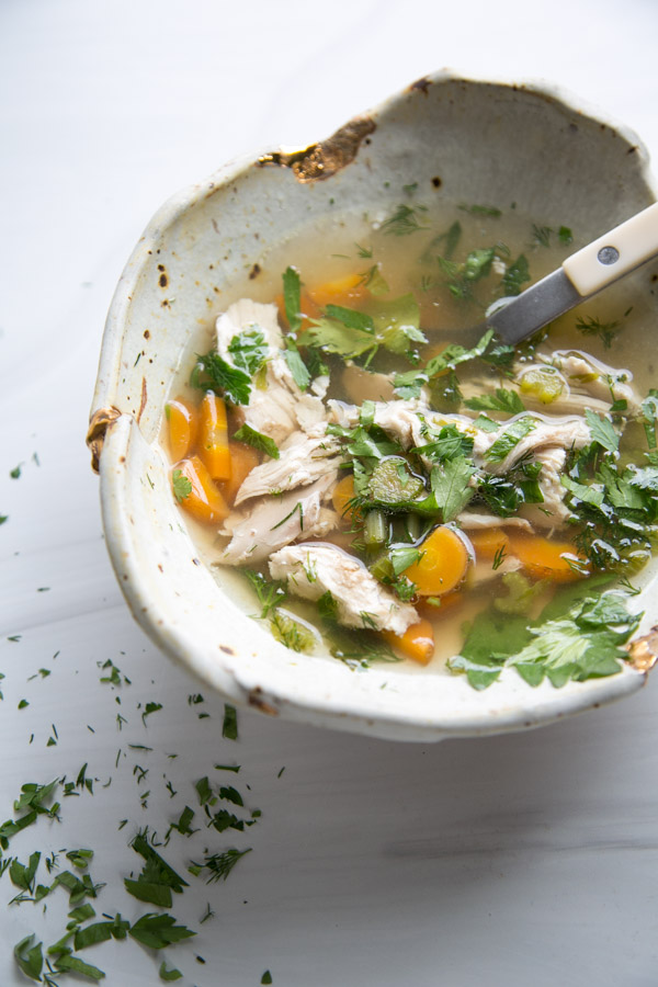 easy jewish chicken noodle soup in a bowl with spoon