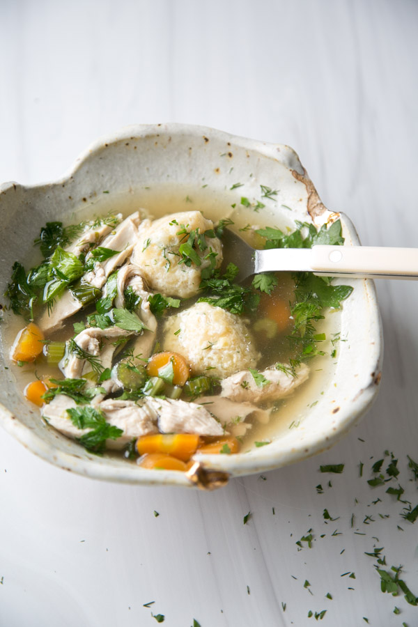 Jewish matzo ball chicken soup for passover seder in a bowl with spoon