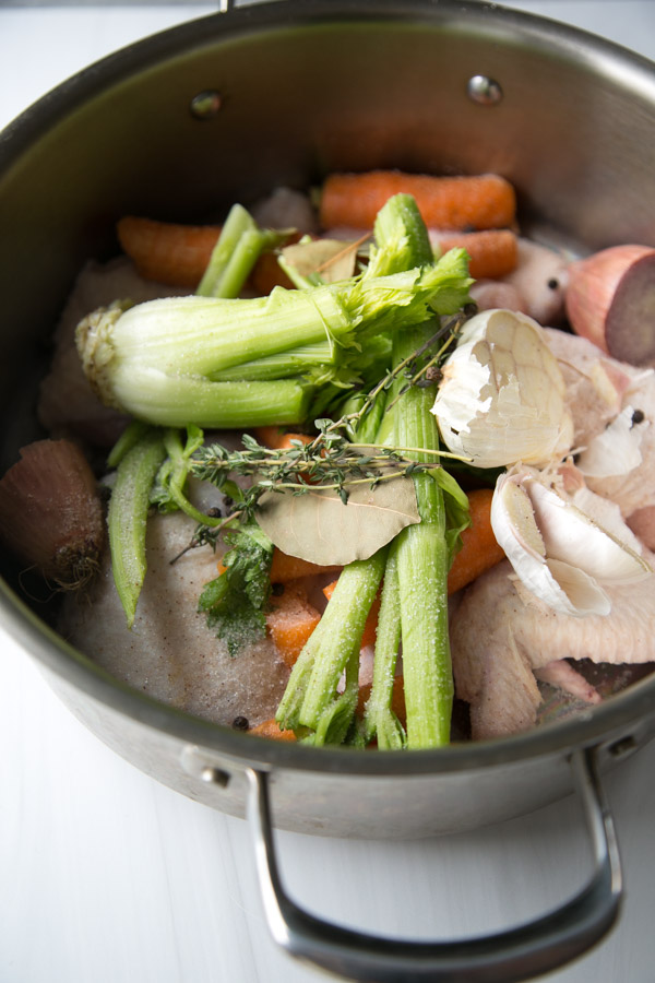 celery garlic carrots bay leaf thyme and chicken in a pot